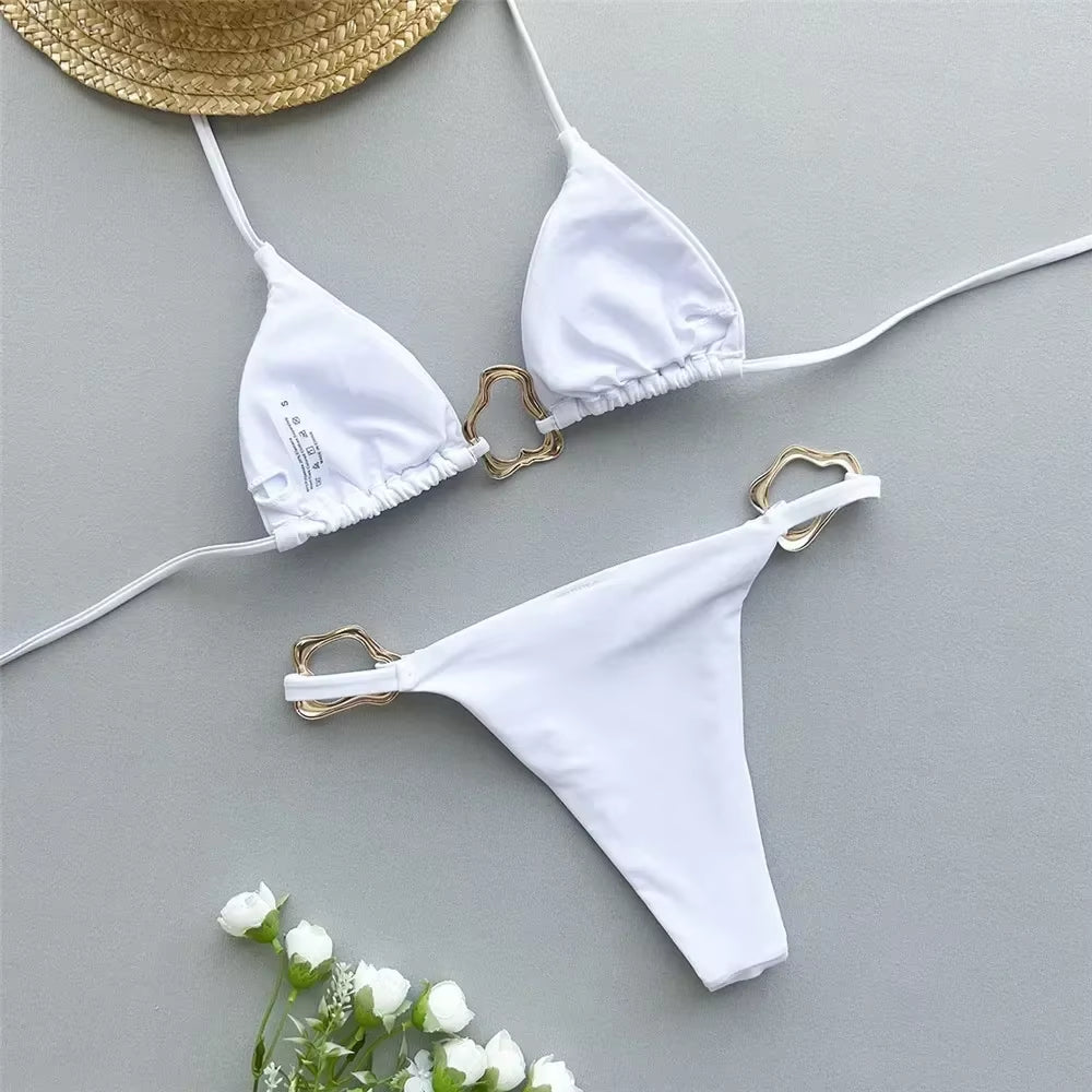 Elegant white triangle bikini set with gold accents, perfect for beach days and summer getaways.
