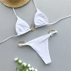 Elegant white triangle bikini set with gold accents, perfect for beach days and summer getaways.