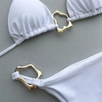 Elegant white bikini set featuring stylish gold accents, perfect for summer swimwear and beach outings.