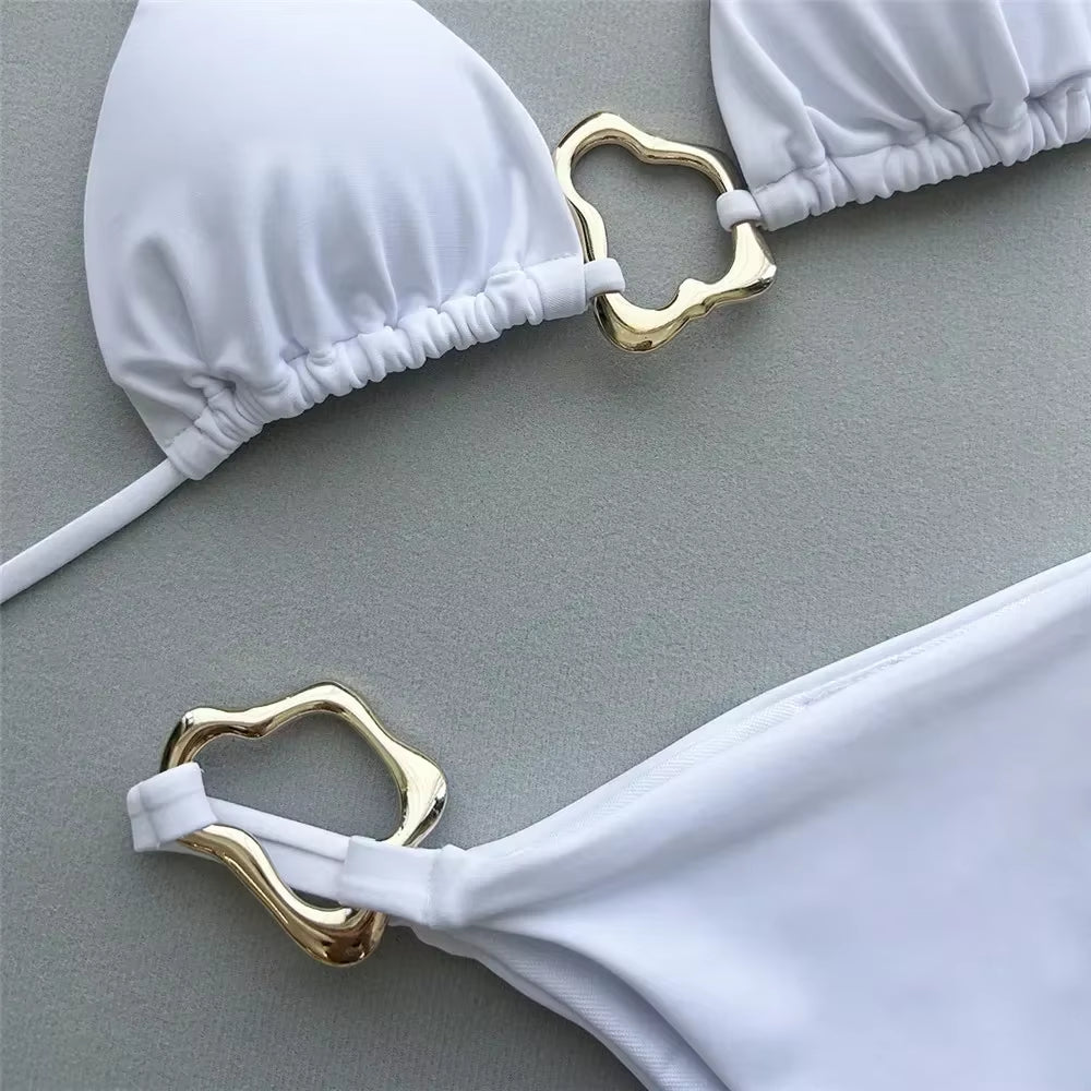 Elegant white bikini set featuring stylish gold accents, perfect for summer swimwear and beach outings.