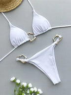 Sleek white triangle bikini set with gold accents, perfect for summer swimwear styles.